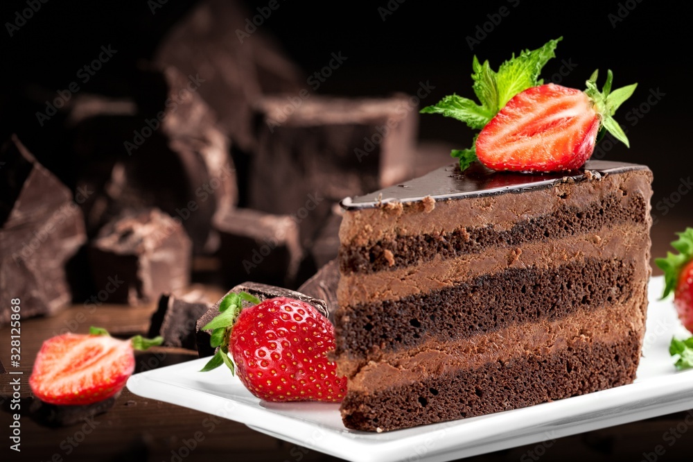 Slice of delicious chocolate cake on the desk