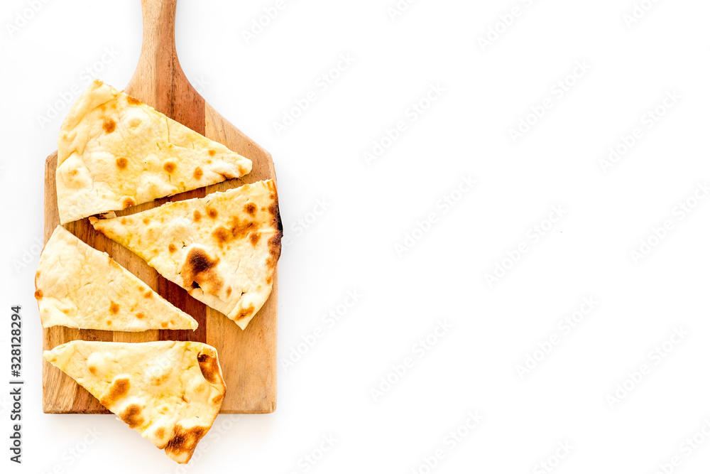 Make focaccia. Traditional italian bread on cutting board on white table top-down copy space