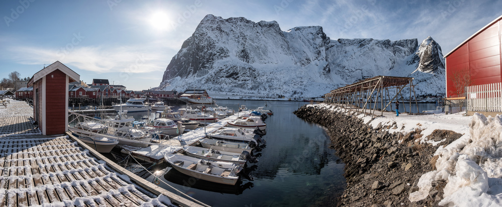 Lofoten islands with fishing village and boats on coastline in winter at Norway