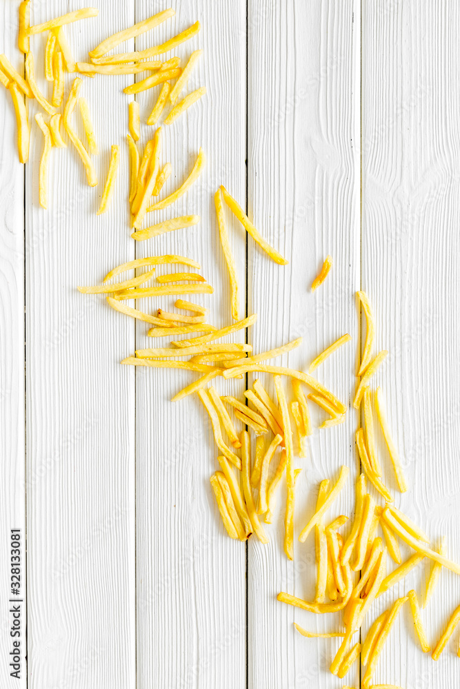 French fries background on white table top-down copy space