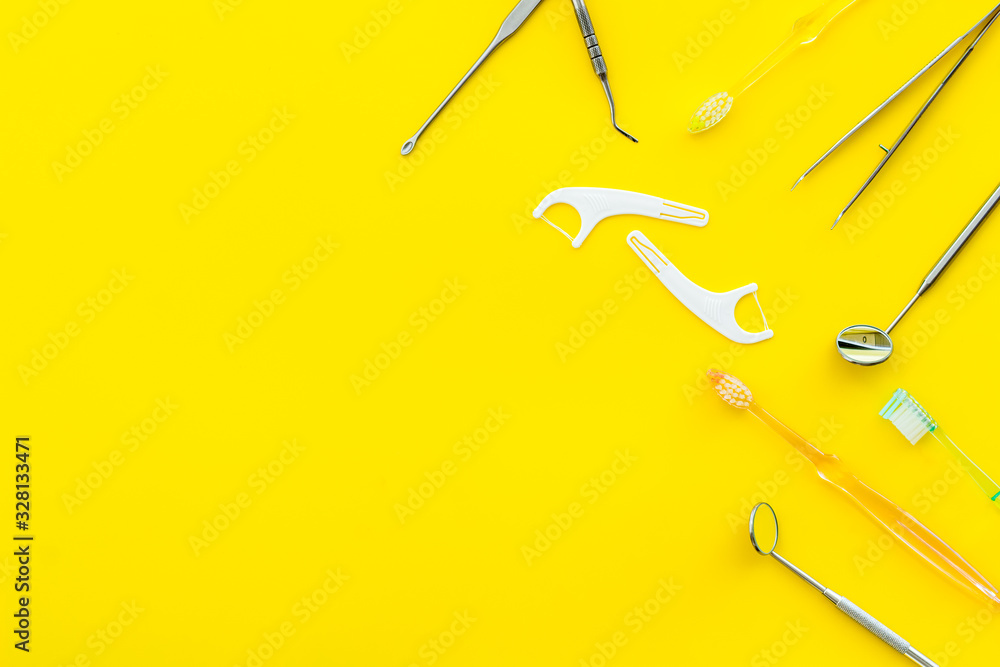 Dental care concept. Stomatological tools frame - with floss - on yellow background top-down frame s