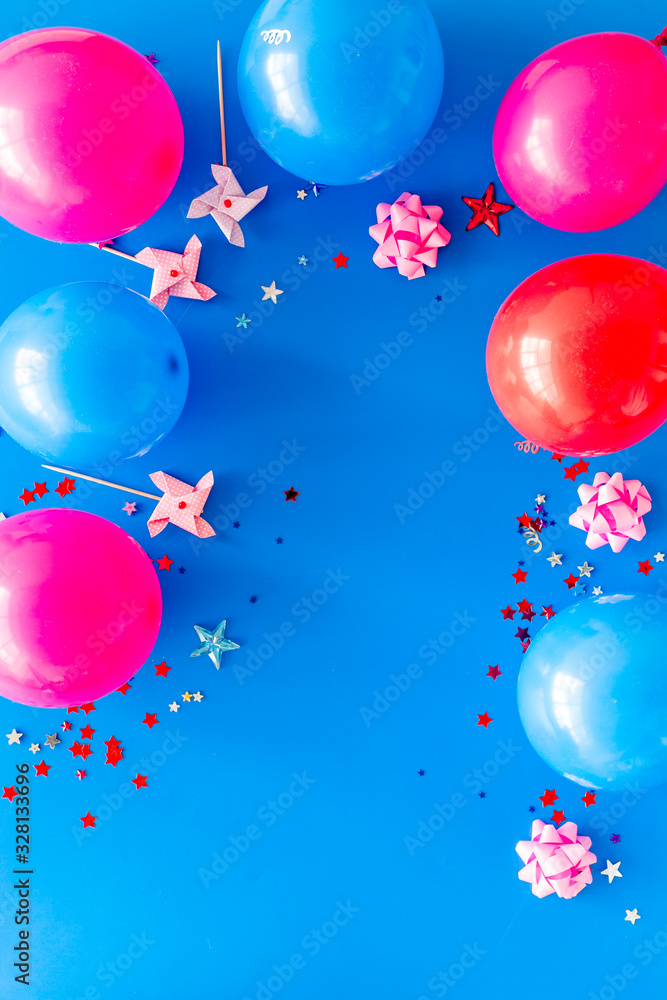 Party concept. Colorful balloons and confetti on blue background top-down frame copy space