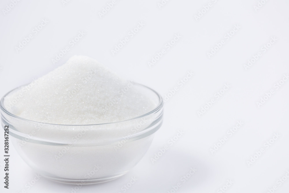 Brown sugar in a round glass cup on a white background, healthy sugar. Used for cooking or desserts.