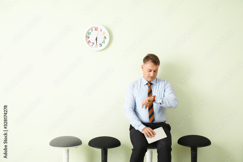 Mature man waiting for job interview indoors