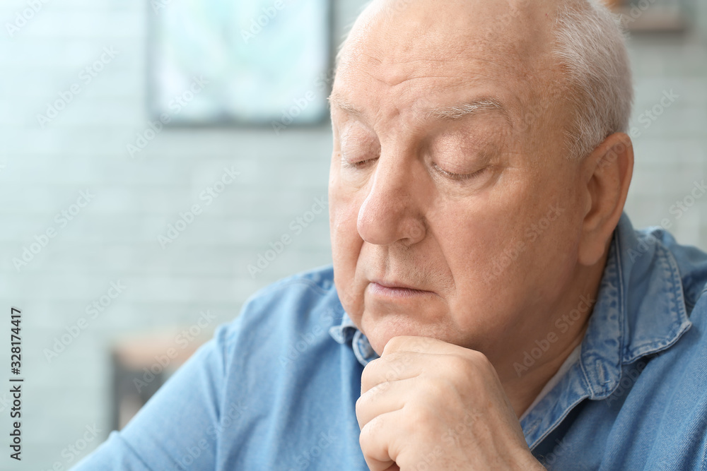 Portrait of elderly man at home