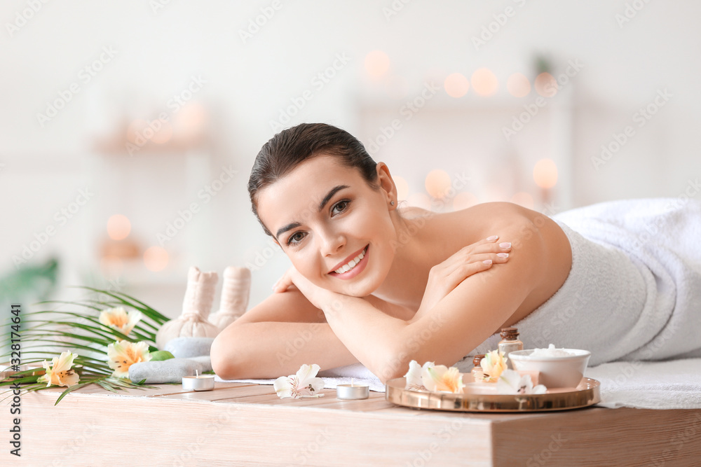 Beautiful young woman relaxing in spa salon