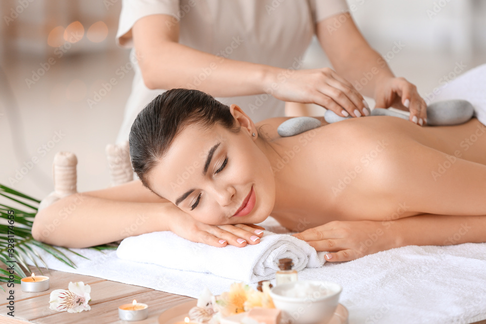 Beautiful young woman relaxing in spa salon