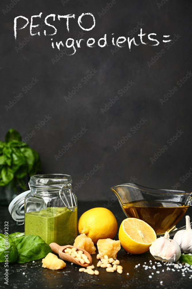 Pesto sauce with ingredients on dark background