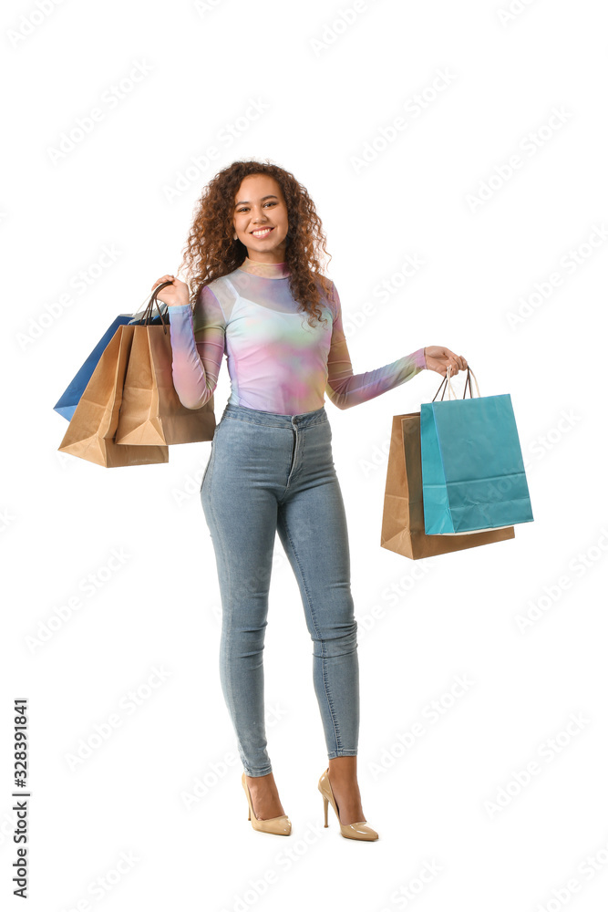 Beautiful young woman with shopping bags on white background