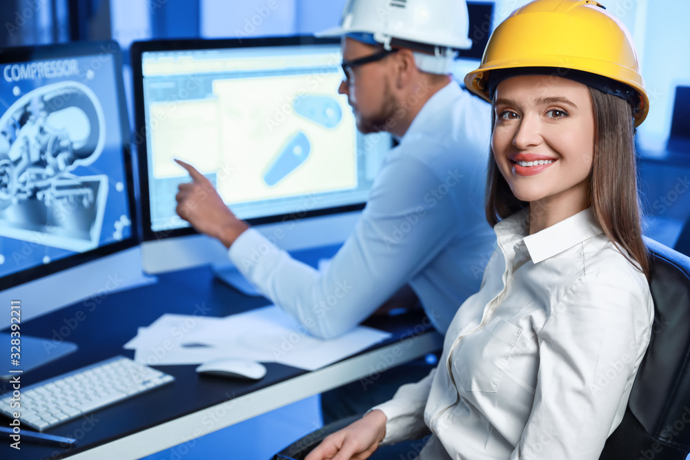 Portrait of female engineer in office at night