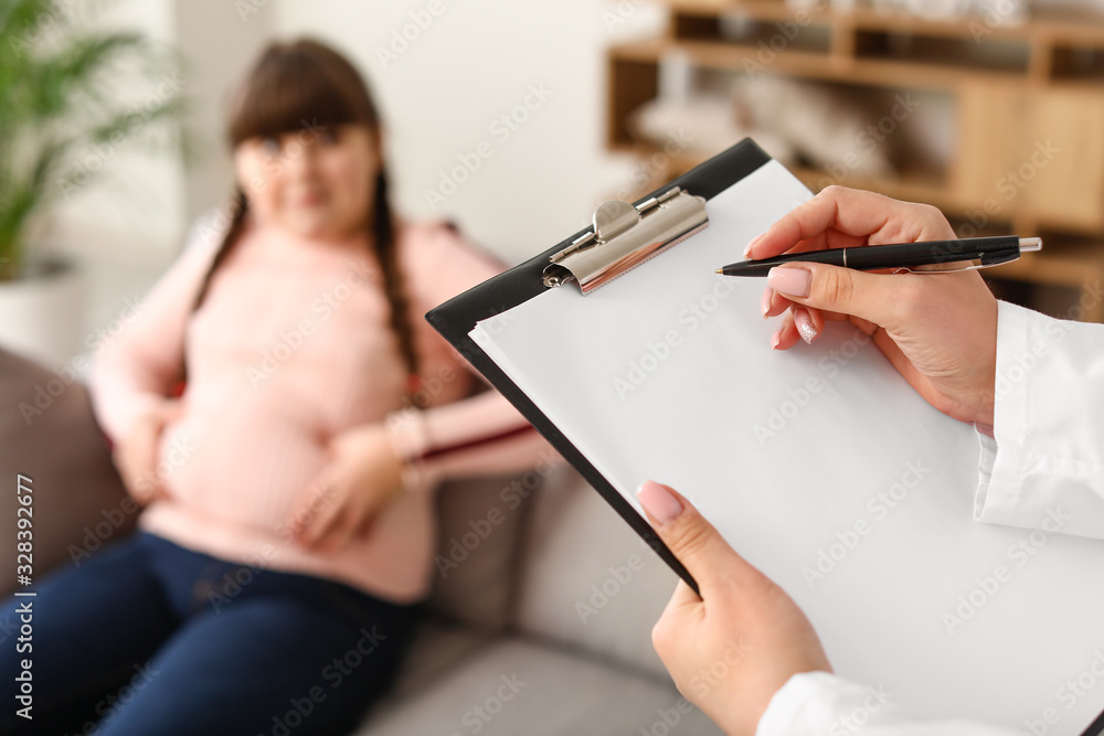 Doctor examining fat girl in clinic, closeup