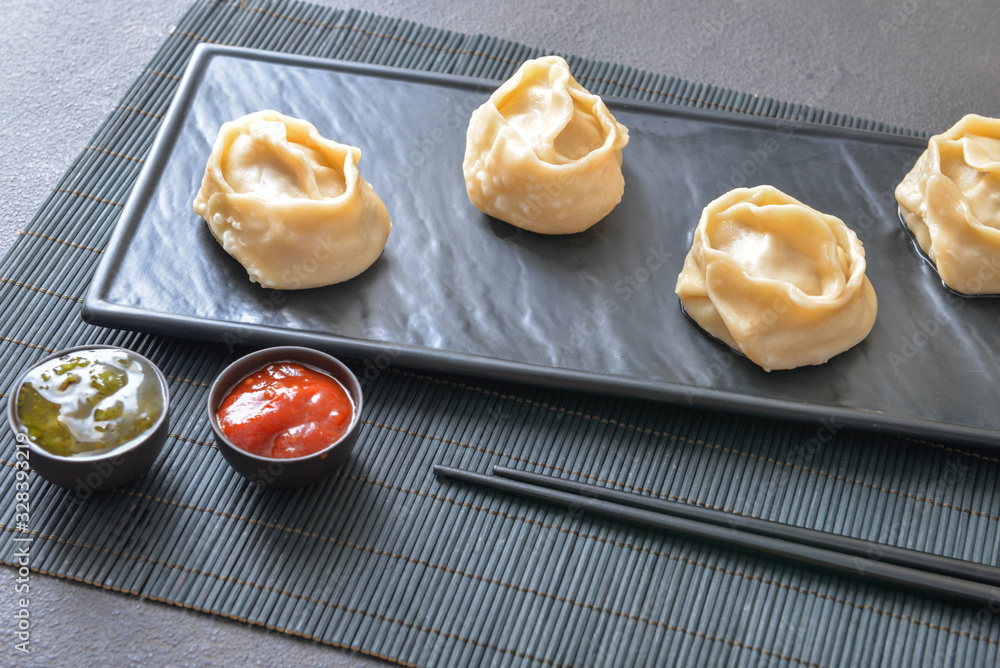 Plate with oriental dumplings on table