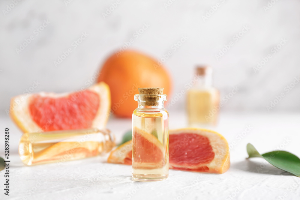 Bottles of grapefruit essential oil on table