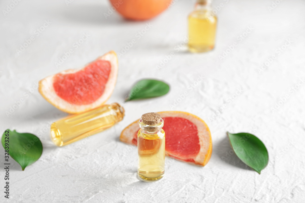 Bottles of grapefruit essential oil on table