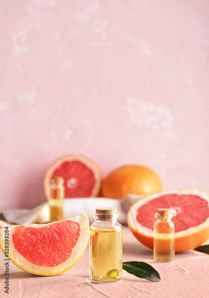 Bottles of grapefruit essential oil on table