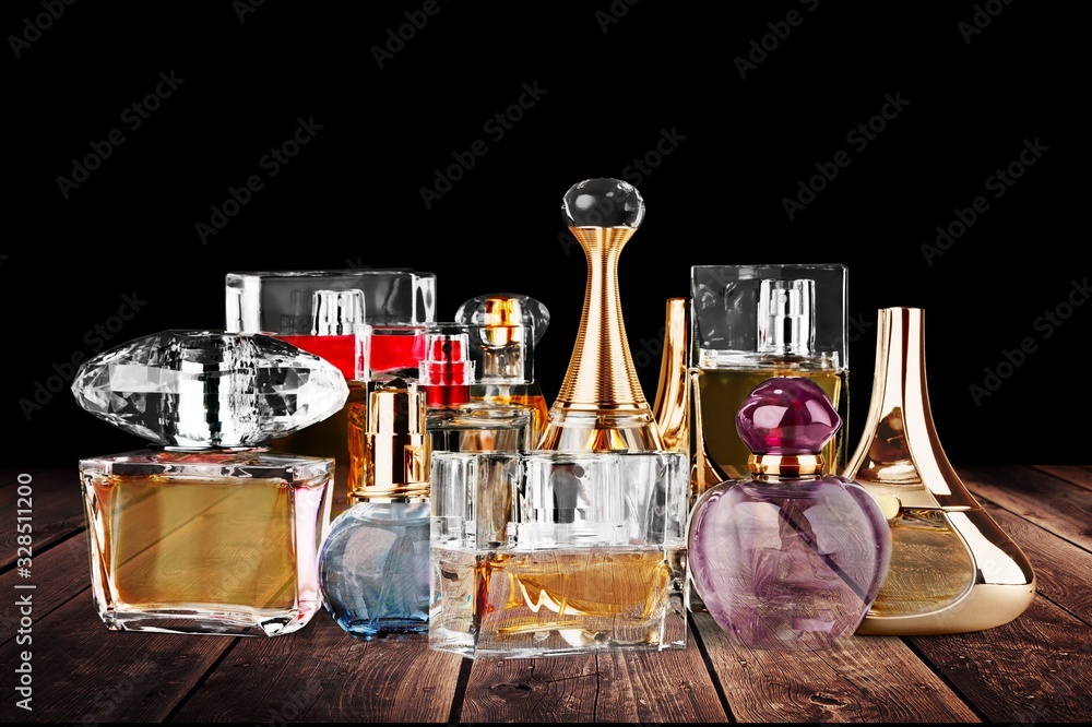 Collection of colored glass perfume bottles on the desk