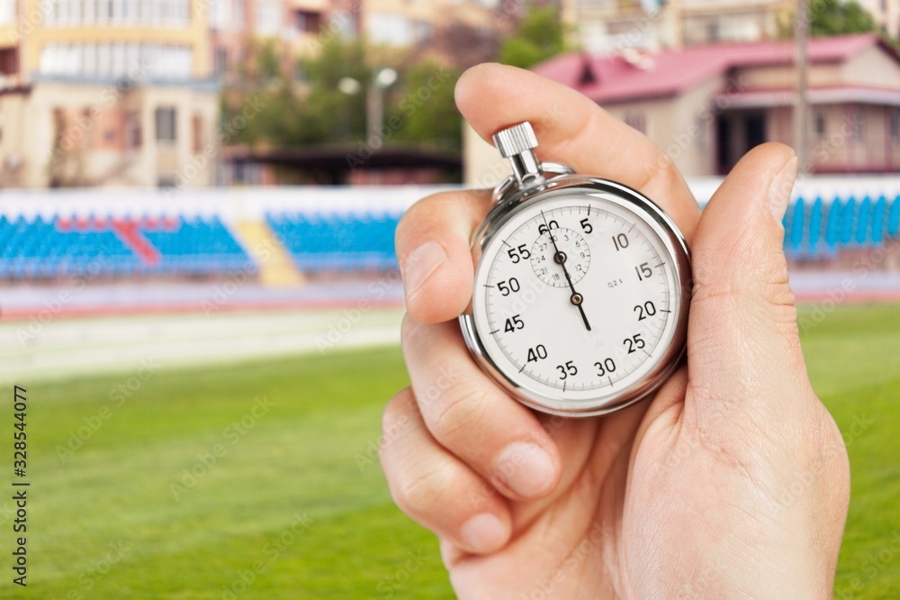 Classic metal stopwatch in human hand