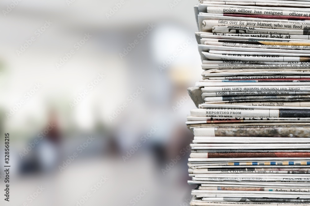 Pile of fresh newspapers on a blur background