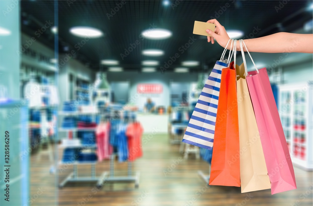 Woman hand with many shopping bags and credit card