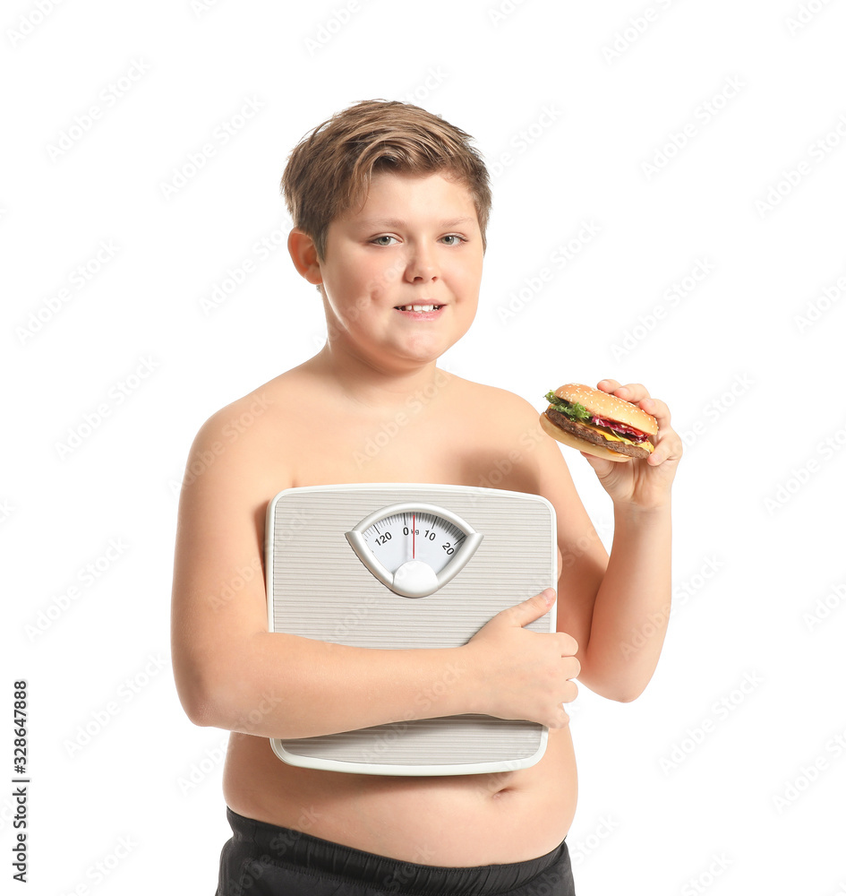 Overweight boy with burger and scales on white background