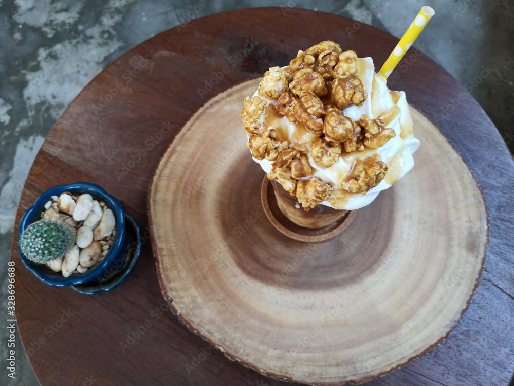 Caramel popcorn coffee on a wooden tray