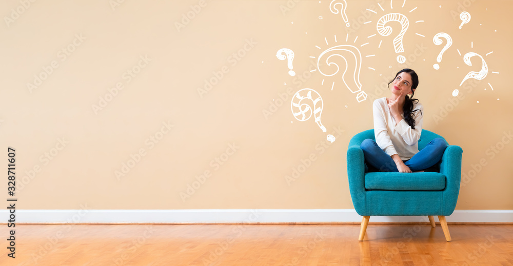 Question marks with woman in a thoughtful pose in a chair