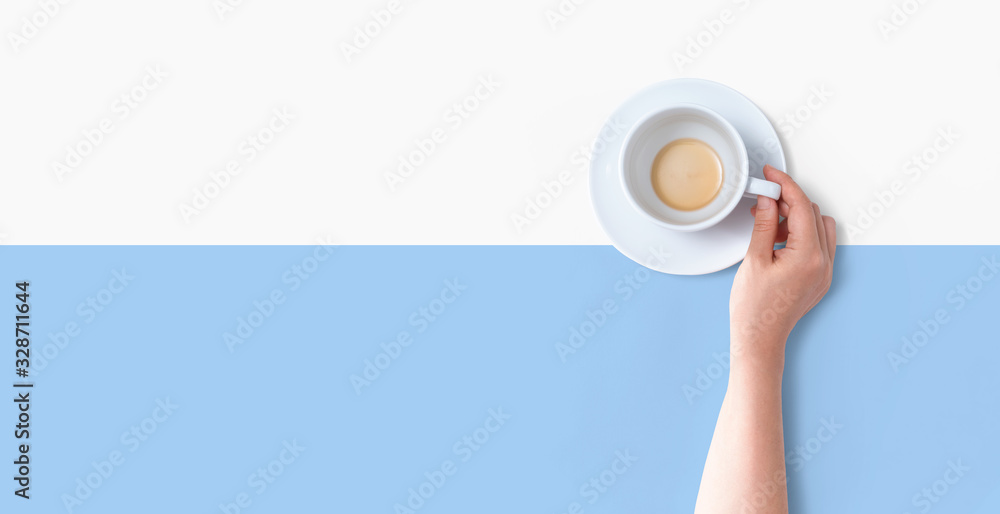 Female hand holding a tea cup overhead view - flat lay