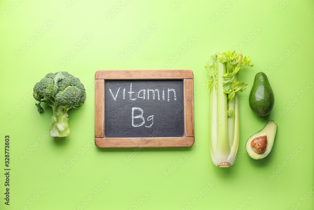 Healthy products rich in vitamin B9 on color background