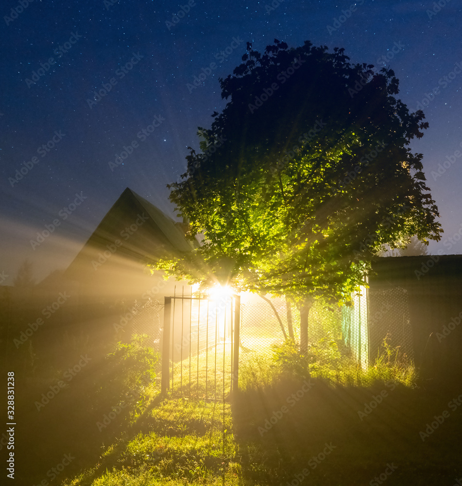 Country house at night in the fog.