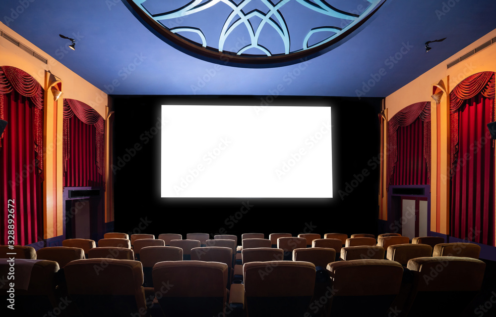 Cinema theater screen in front of seat rows in movie theater showing white screen projected from cin