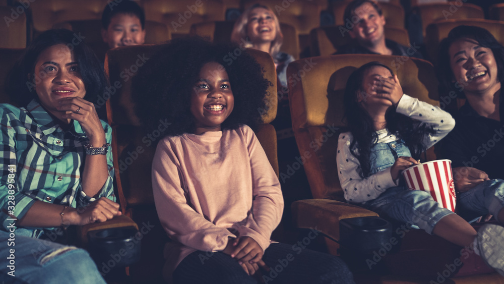 People audience watching movie in the movie theater cinema. Group recreation activity and entertainm