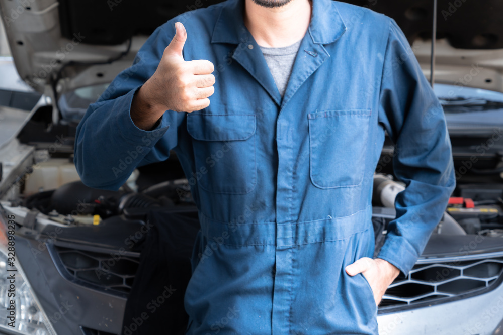 Professional mechanic providing car repair and maintenance service in auto garage. Car service busin