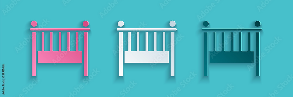 Paper cut Baby crib cradle bed icon isolated on blue background. Paper art style. Vector Illustratio