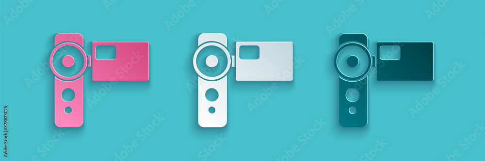 Paper cut Cinema camera icon isolated on blue background. Video camera. Movie sign. Film projector. 