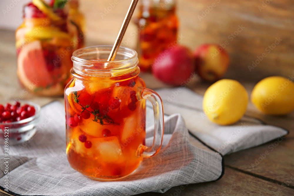 Mason jar of cold tea on wooden table