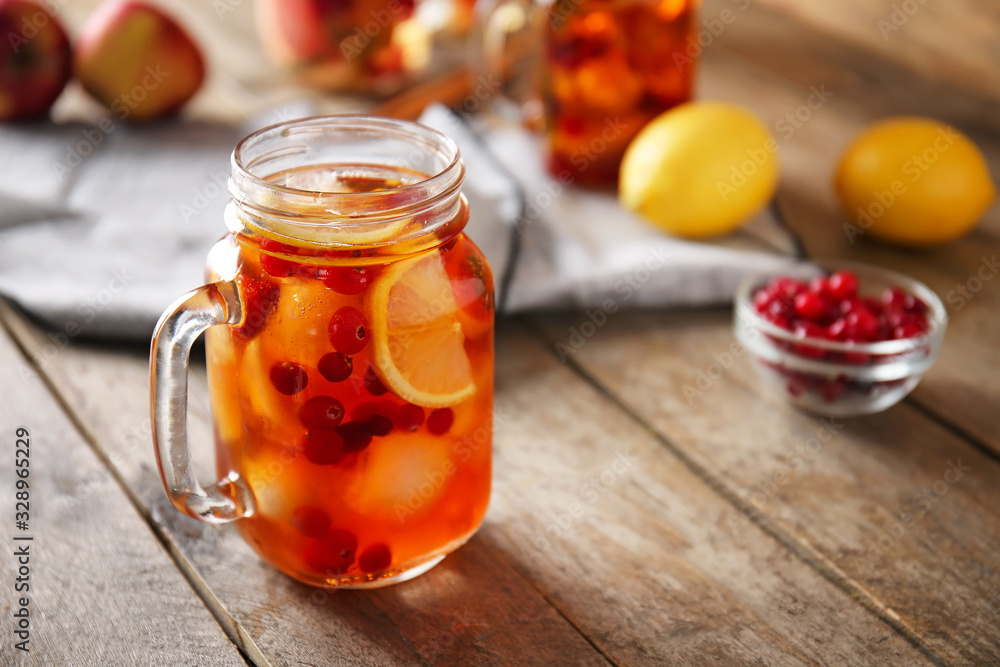 Mason jar of cold tea on wooden table