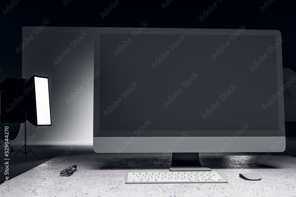 Photo studio with blank computer screen