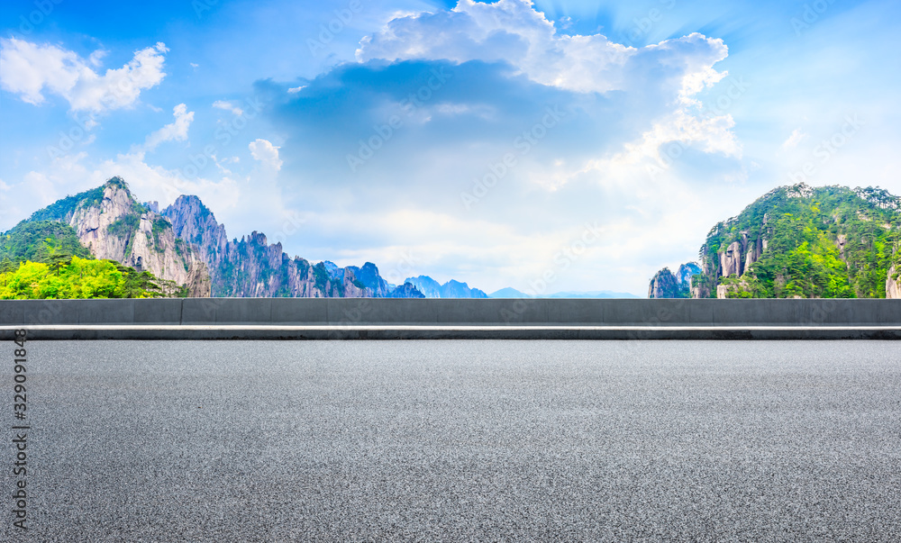 Empty asphalt road and green mountain with beautiful clouds,panoramic view.