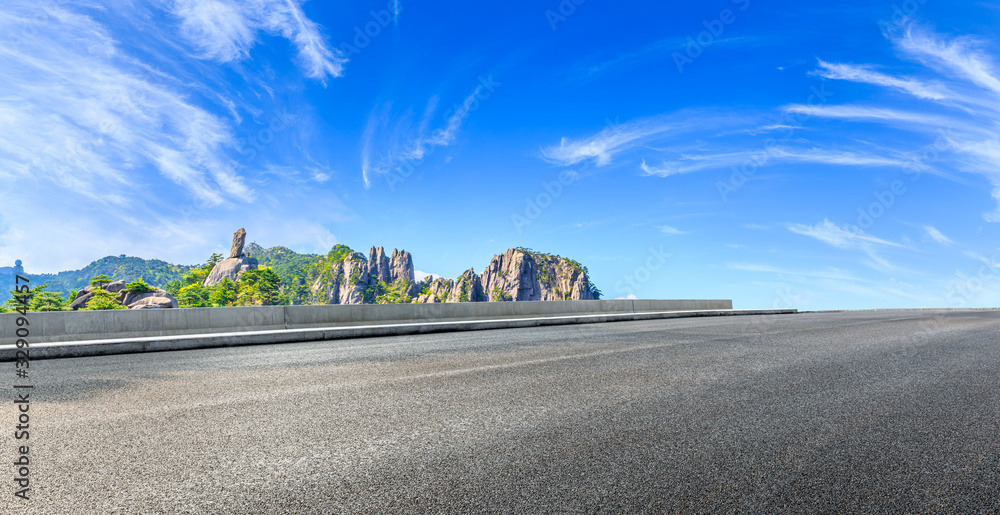 Empty asphalt road and green mountain with beautiful clouds,panoramic view.