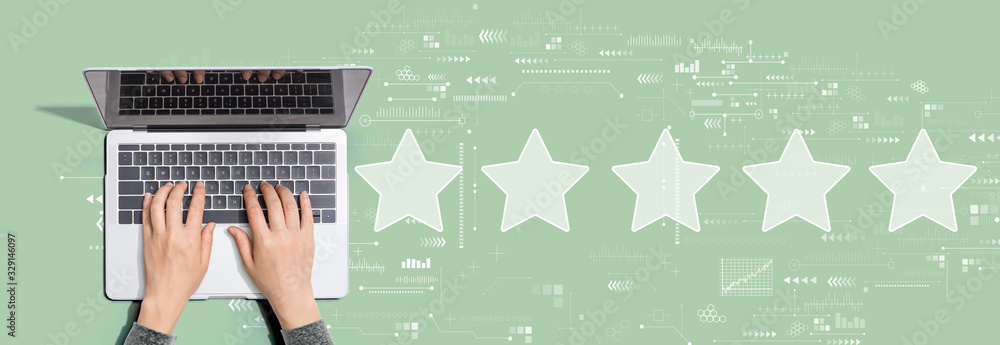 Rating star concept with person using a laptop computer