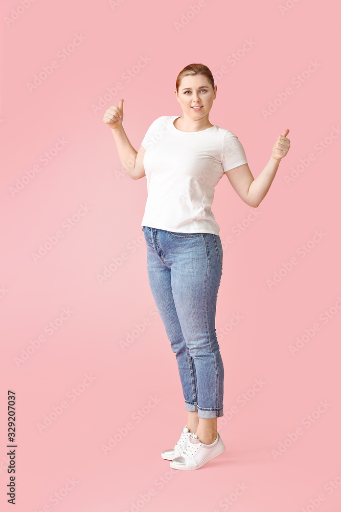 Overweight woman showing thumb-up on color background. Weight loss concept