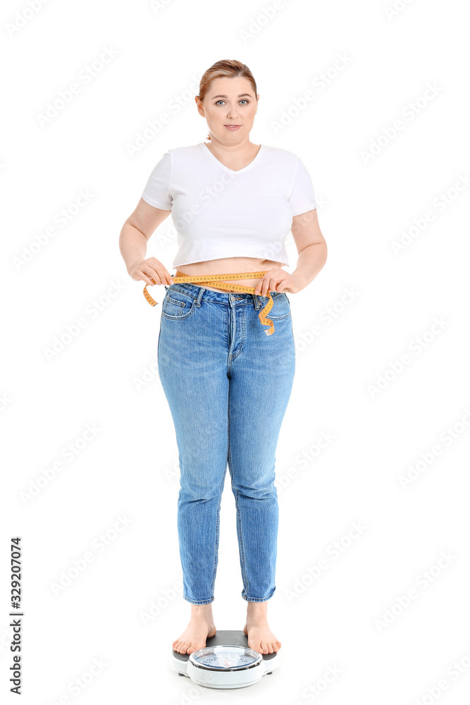 Overweight woman on scales against white background. Weight loss concept