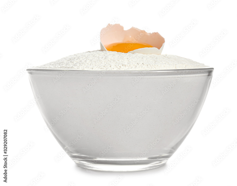 Raw chicken egg and flour in bowl on white background