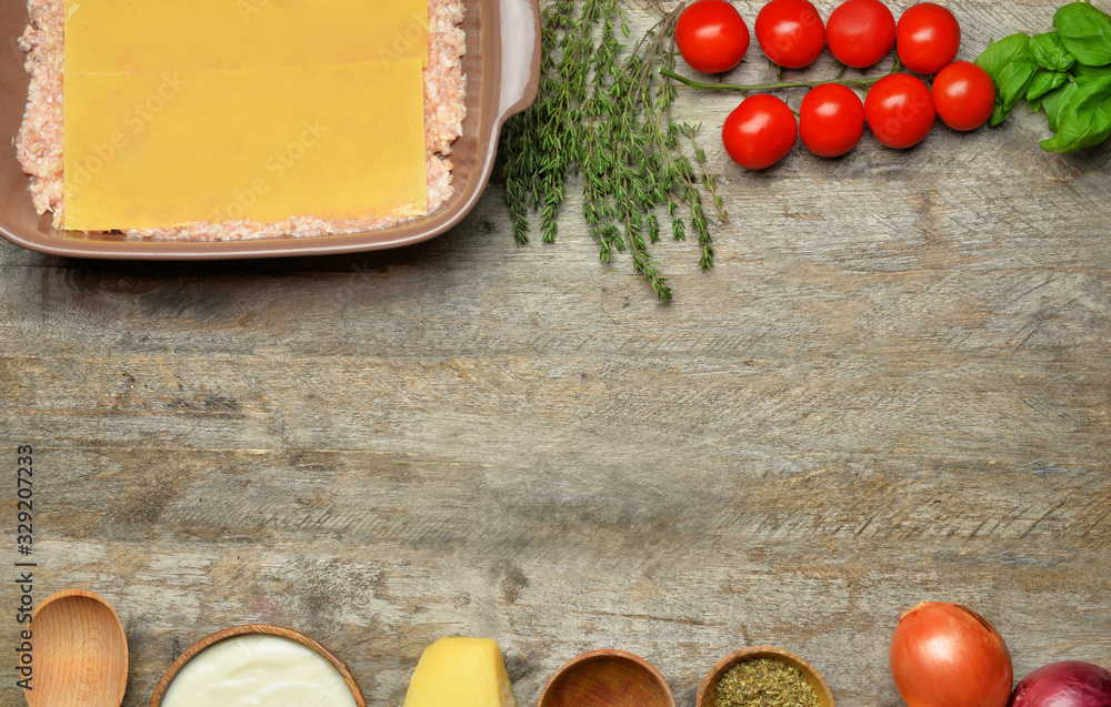 Ingredients for lasagna on wooden background