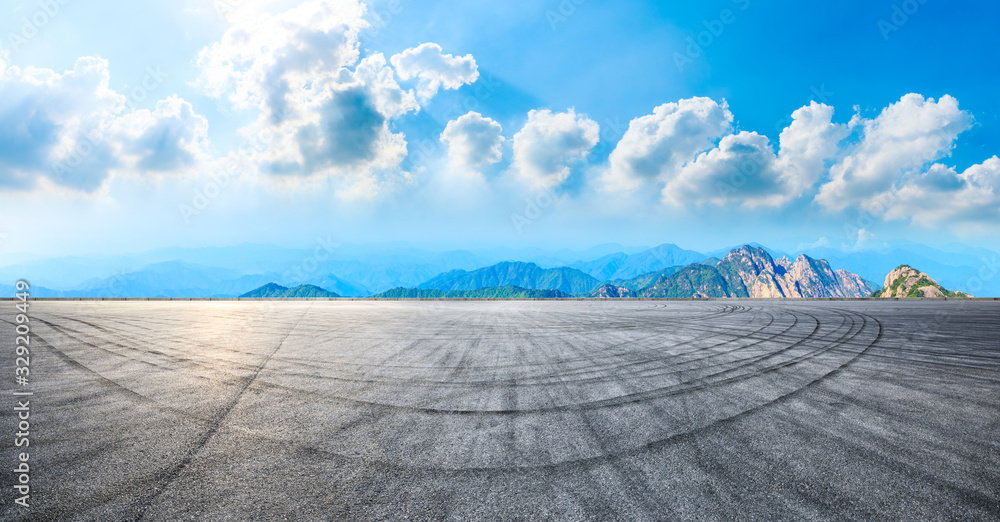 Empty race track road and green mountain with beautiful clouds,panoramic view.