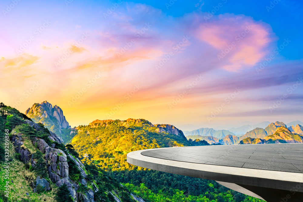 Empty square floor and green mountain with beautiful clouds at sunrise.