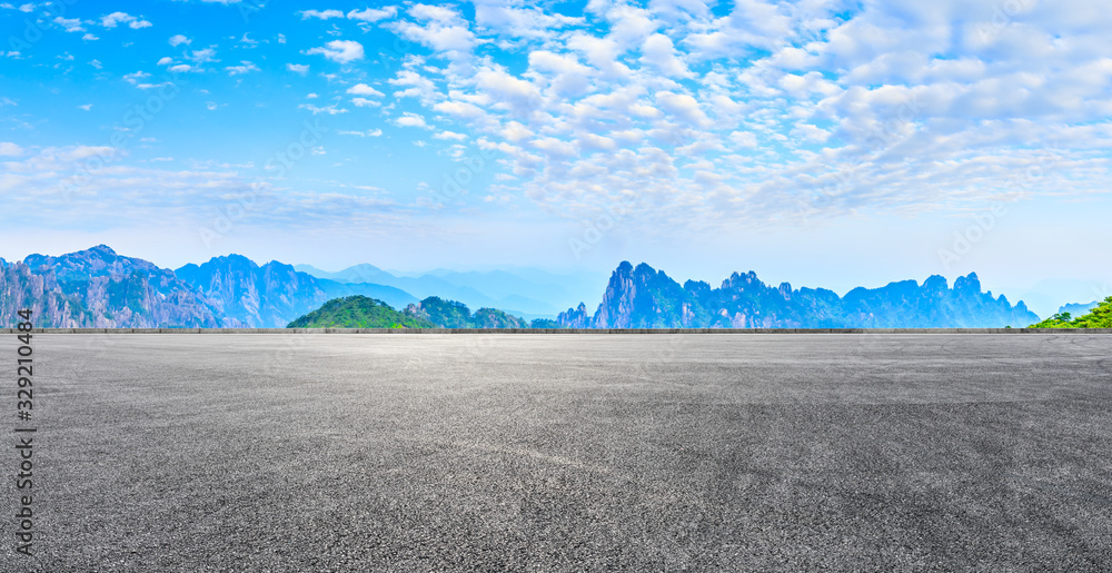 Empty race track road and green mountain with beautiful clouds,panoramic view.