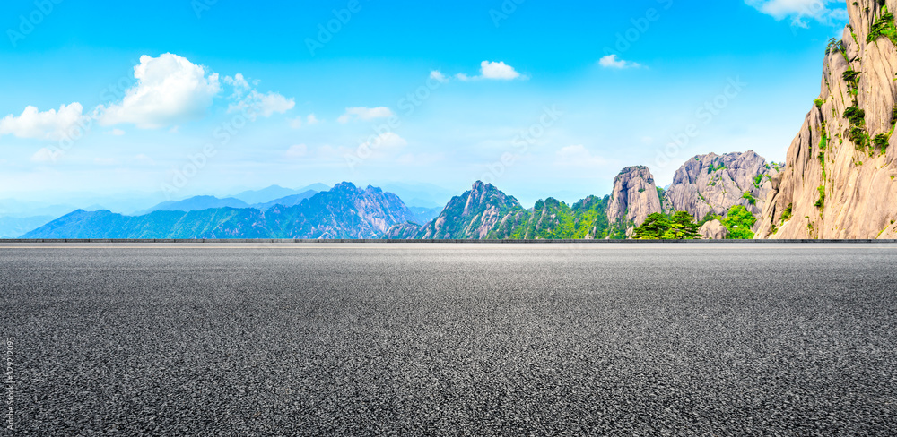 Empty asphalt road and green mountain with beautiful clouds,panoramic view.