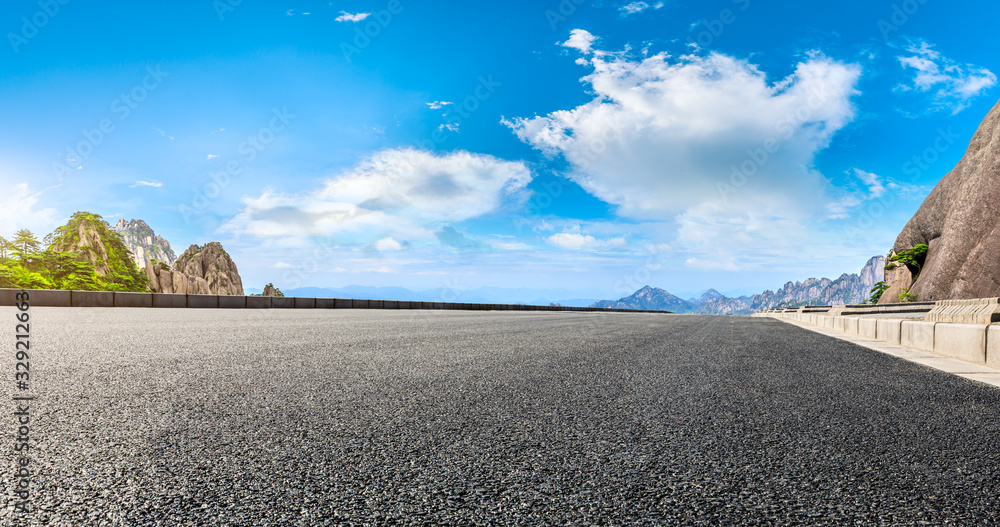 Empty asphalt road and green mountain with beautiful clouds,panoramic view.