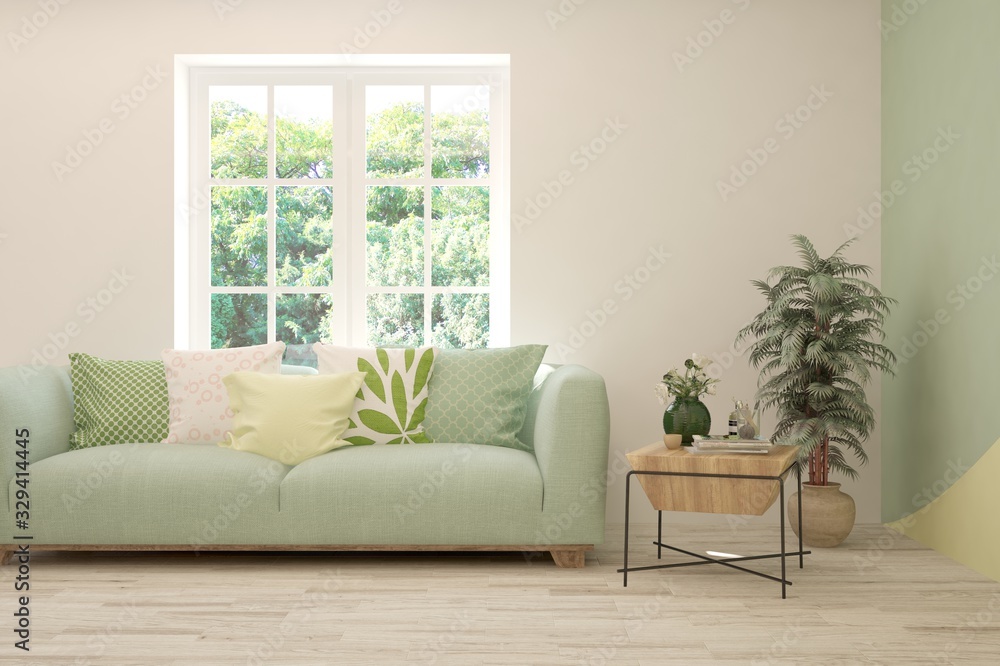 Minimalist living room in white color with sofa and summer landscape in window. Scandinavian interio